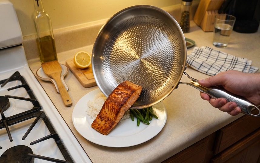 The TIBO titanium pan searing food evenly on a stovetop