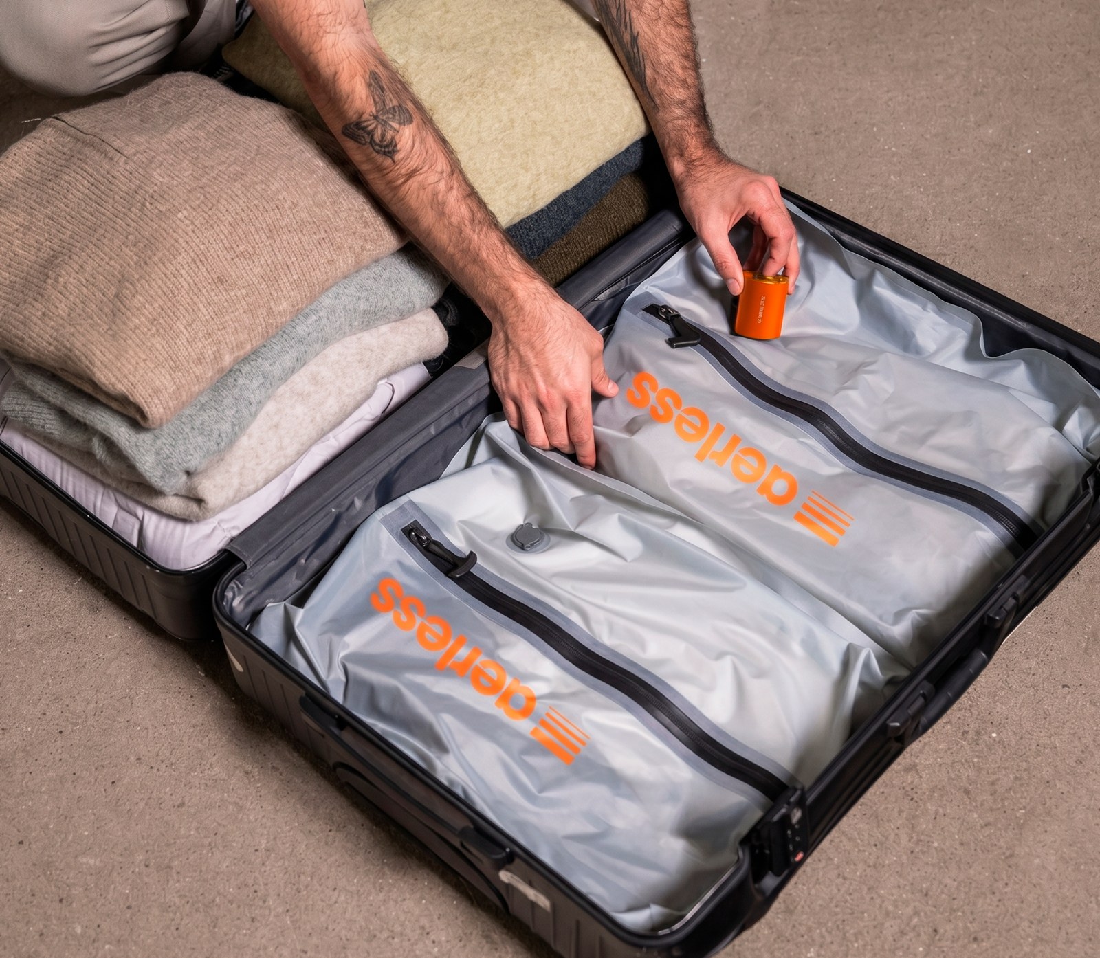 An Aerless Turbo Pump vacuum-compressing packed bags inside an open suitcase